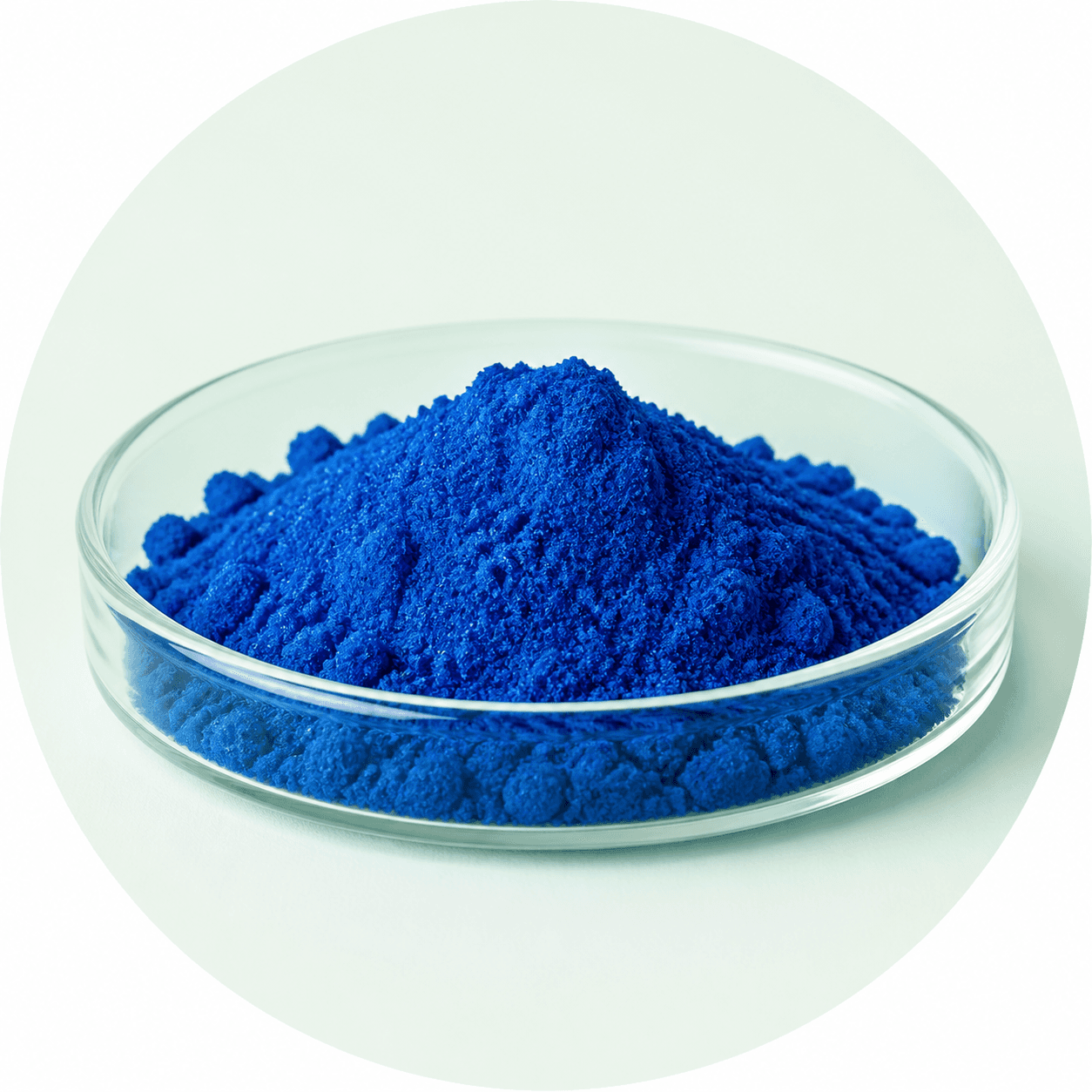 Vivid blue Copper Tripeptide-1 GHK-Cu powder in a glass dish